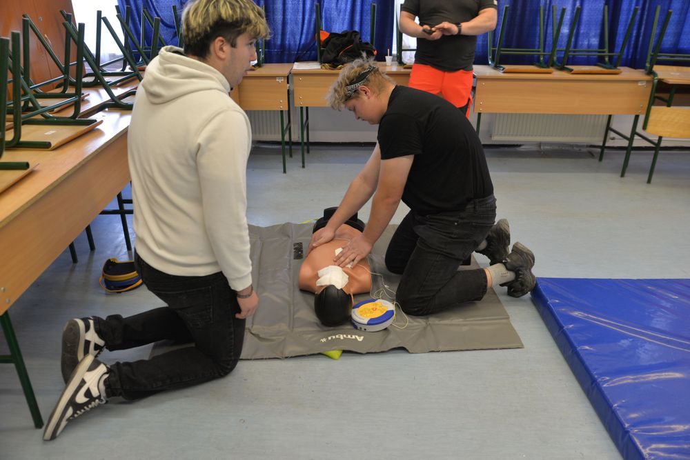 Stock photograph of a learner practicing CPR on a manikin during classroom training